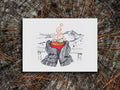 Art print illustration of thick winter mittens holding a red cup of hot chocolate, with mountains and chair lift in the background, displayed on a wooden surface.