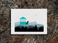 Illustration of a dog in a fire tower overlooking the mountains on a wooden surface.