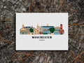 Art print of buildings arranged in a skyline with the text Manchester Vermont