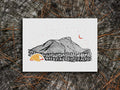 Art print of a yellow and orange tent with a mountain in the background and starry night sky