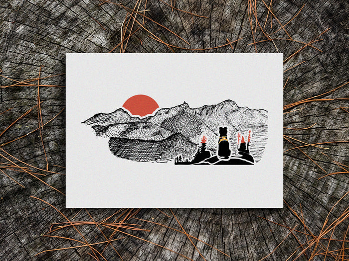 Art print of black dog looking at a mountains with red sunset