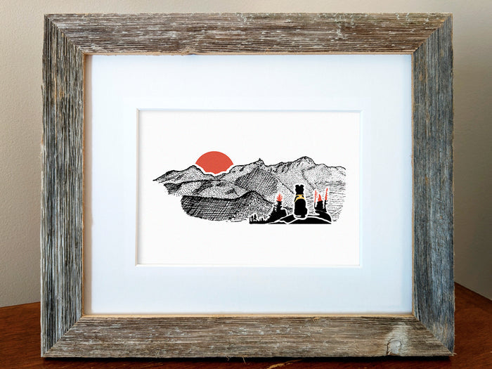 Framed art print of black dog looking at a mountains with red sunset