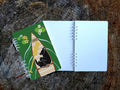 Notebook with illustration of dog sleeping in a canoe with text No Wake Zone.