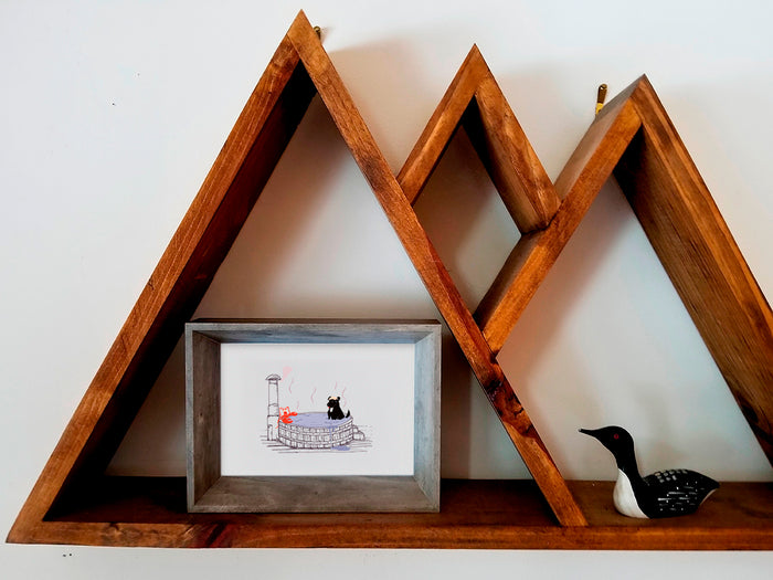 Framed illustration of a dog in a hot tub with a lobster on a wooden shelf.
