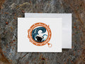 Greeting card with image of a dog looking through a porthole.