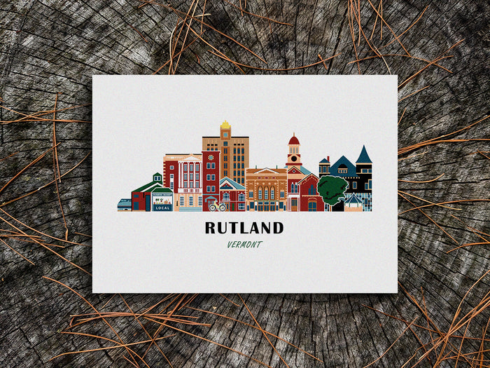 Art print of buildings arranged in a skyline with the text Rutland Vermont