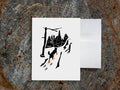 Greeting card with image of dog walking through forest wearing yellow snowshoes.