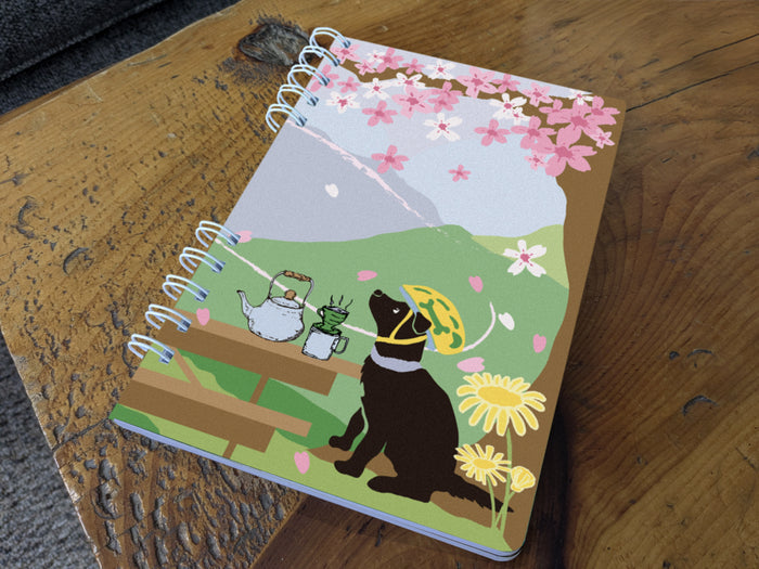 Notebook with a dog illustration on a wooden surface